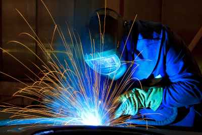 Welder using shield gases at an industrial facility