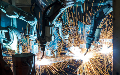 Welding robots at an industrial facility
